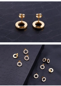 Detailed view of gold circular crystal stud earrings with a polished finish and secure backing