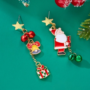 Detail view of asymmetric Christmas earrings with Santa and red bow on green background