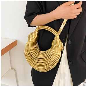 Golden woven handbag with unique noodle strap texture and decorative metallic knots