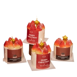 Set of four strawberry cream Christmas scented candles with gold stars for holiday decor