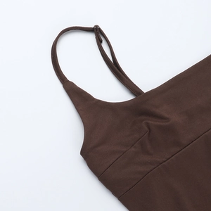 Detailed macro view of adjustable thin shoulder straps on dark brown knit mini dress