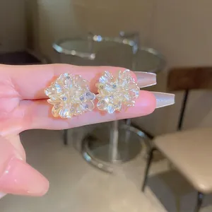 Elegant floral stud earrings with translucent petals and sparkling center crystals