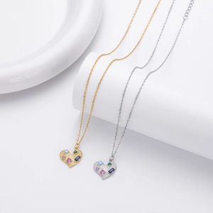 Detail of heart pendants with colorful stones in gold and silver finishes