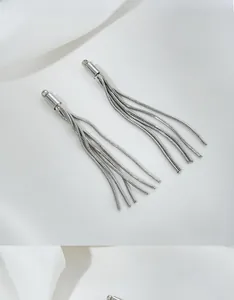 Macro shot of silver snake chain tassels for DIY jewelry making with metallic texture