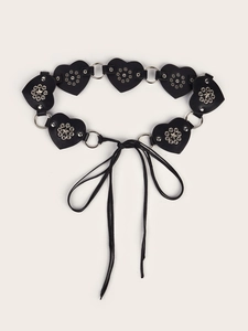 Detail of heart-shaped leather panels connected by metal rings and silver studs