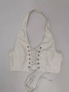 Close-up of white PU leather halter top with metallic eyelets and crisscross tie detail