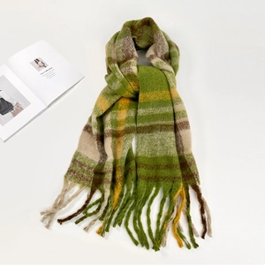 Close-up of soft green and yellow plaid mohair scarf with long tassel textures