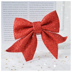 Detail of a large red glitter bow ornament with a sparkling texture for Christmas decor