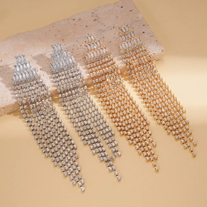 Detail of elegant gold and silver tassel drop earrings with sparkling zircon fringe
