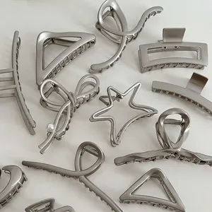 Elegant silver metal hair claw clips set with bow and star designs on white background