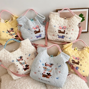 Detailed embroidery on soft quilted cotton crossbody bags in yellow, blue and cream white