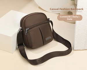 Detail of a brown nylon crossbody bag featuring silver hardware and a JIELSHI branded strap