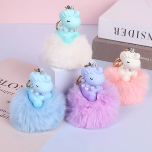 Detailed view of colorful unicorn plush ball keychains on professional display stands