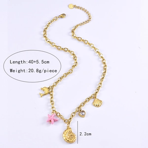 Detail view of a gold ocean theme necklace with shell, starfish, dolphin, and heart pendants