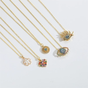 Macro shot of gold-tone necklaces with diverse Devil's Eye and floral pendant designs