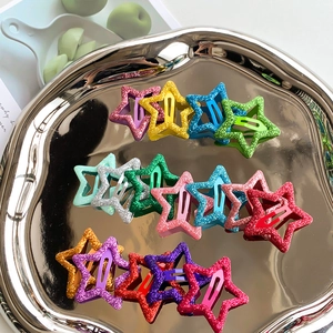 Colorful glitter star hair clips in Y2K style for girls on a silver metal tray