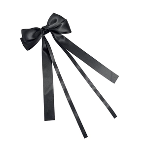 Elegant black satin bow hair clip with long flowing ribbons for a minimalist hairstyle