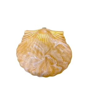 Chic shell-shaped clutch bag in amber marble finish with vintage metal clasp and chain
