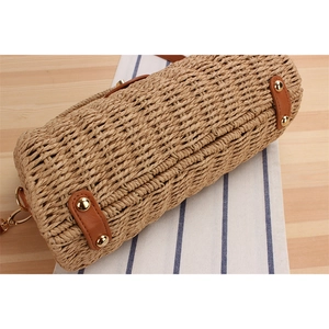 Handcrafted cylindrical straw woven crossbody bag with brown PU leather trim and gold hardware