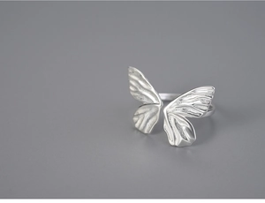 Detailed close-up of S925 silver butterfly ring with adjustable band on gray background