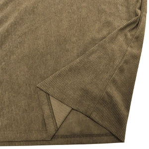 Macro shot of khaki corduroy fabric texture and hem stitching on long-sleeve polo shirt