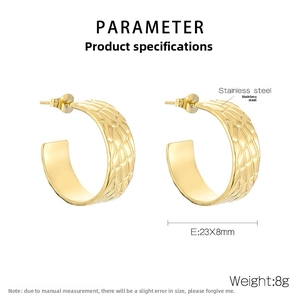 Macro detail of 18k gold plated stainless steel C-hoops with textured crocodile pattern