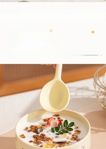 Detailed view of yellow ceramic bowl with heart texture holding yogurt and strawberry