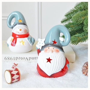 Detailed view of hollow star ceramic Santa and snowman figurines on festive snow