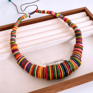 Detail of colorful wooden coconut shell beads on adjustable ethnic style necklace string