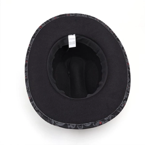 Top view of black skull print jazz hat interior with 100% polyester wash label details