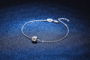 Macro detail of S925 sterling silver chain with moissanite stone and adjustable logo tag