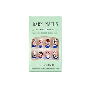 Gothic press-on nails with dark art patterns like skulls and snakes in a 24-piece set