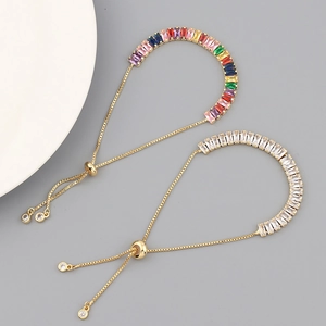 Adjustable gold bracelets featuring vibrant rainbow and white baguette-cut cubic zirconia