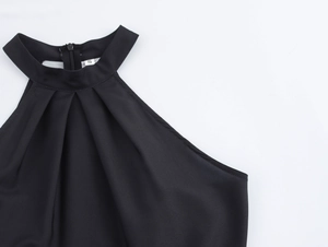 Close-up of black satin halter dress neckline with pleated details and S size label