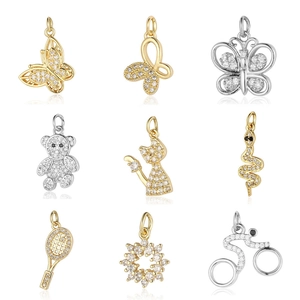 Assorted gold and silver DIY jewelry pendants with cubic zirconia in a 3x3 grid layout