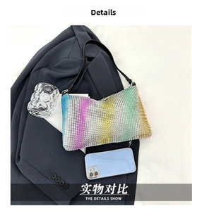 Detail shot of rainbow gradient rhinestones on the shoulder bag next to a smartphone