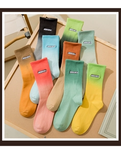 Flat lay of colorful gradient cotton socks featuring Aurora embroidery detail