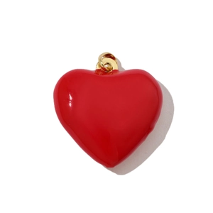 Macro detail of a 3D red heart pendant with a polished gold finish for jewelry making