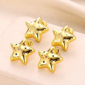 Macro shot of gold star earrings featuring colorful and white cubic zirconia crystals