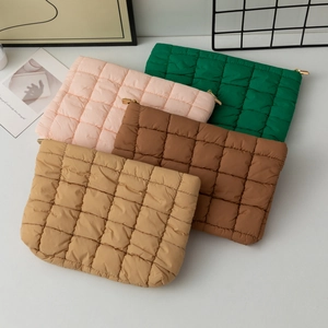 Quilted puffer clutch bag in various colors with metallic zipper and minimalist design