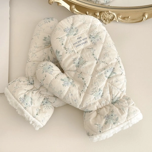Detail of floral mittens showing thick faux shearling lining and quilted fabric