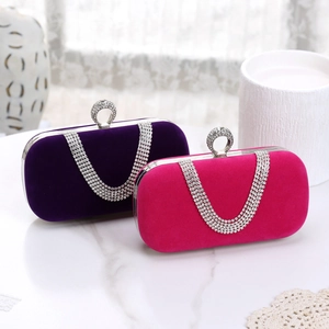 Detail of velvet evening bags with rhinestone encrusted U-shaped metal handles