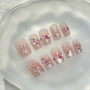 Handmade pink cat-eye press-on nails with 3D butterfly, pearls and rhinestone accents