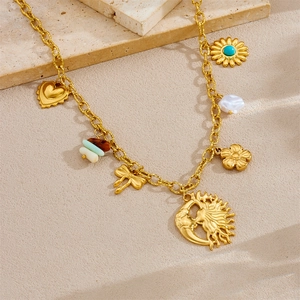 Golden pendant necklace with charms like moon, sun, flower and turquoise on stone