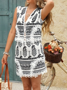 Detail of white paisley print two-piece set with lace trim and bohemian accessories