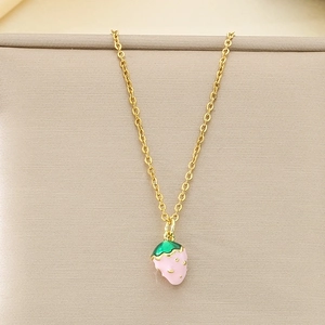 Close-up of a sweet pink enamel strawberry pendant on a fine gold stainless steel chain