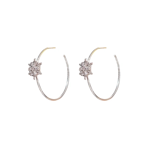 Silver C-shaped hoop earrings with zircon snowflake accents on a white background