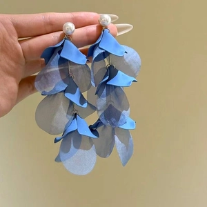 Detailed view of blue chiffon flower earrings with delicate seed beads and pearl studs