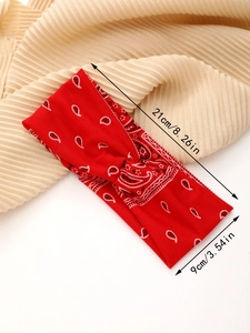 Detail view of red paisley yoga headband with 21cm by 9cm size measurement specs