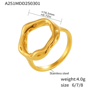 Macro detail of irregular gold lava ring showing 4.0g weight and stainless steel material